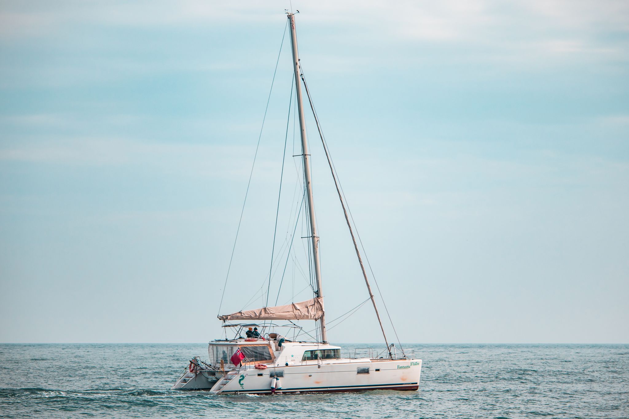 a catamaran sails peacefully on the tranquil