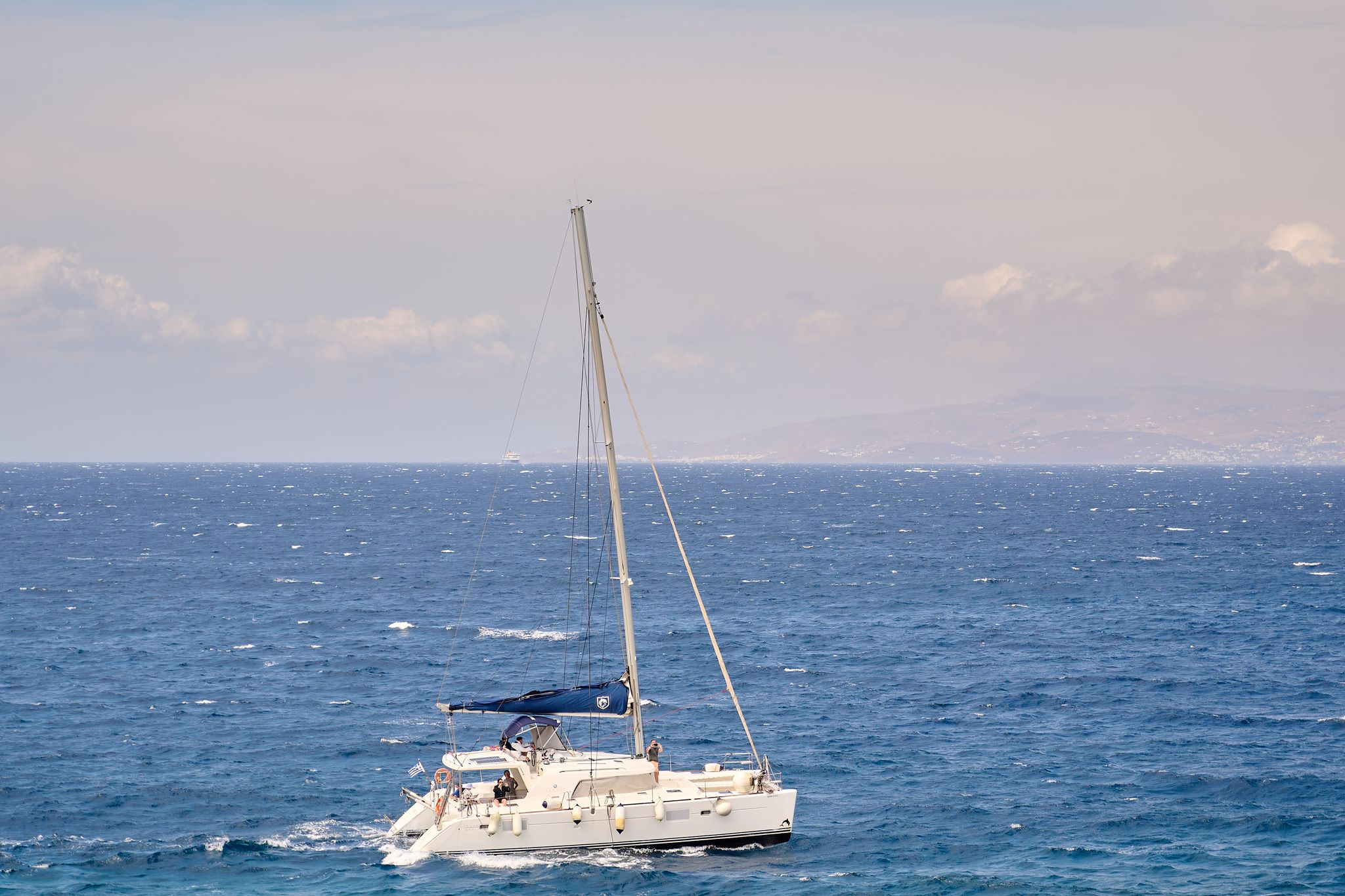 A sailboat cruising through the open sea on a sunny day, perfect for leisure and relaxation.