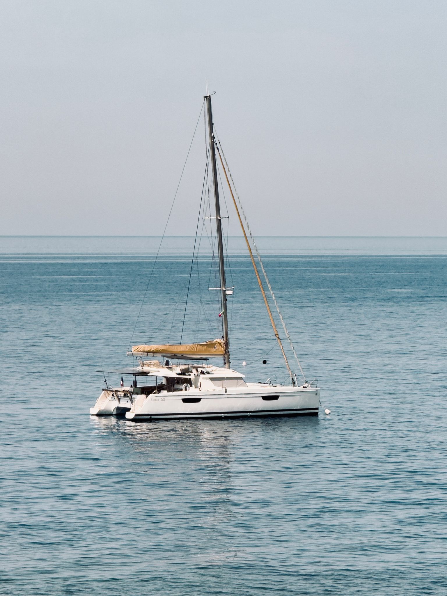 a serene view of a catamaran sailing
